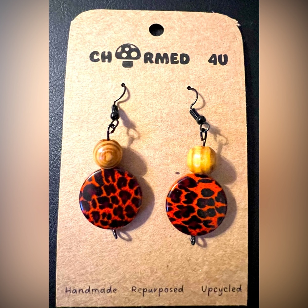 Charmed4U leopard print orange and black dangle earrings with black hardware
